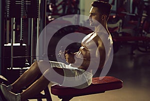 Muscular man training in gym