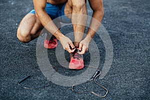 Muscular man warming up before exercise at crossfit ground doing push ups as part of training. Sport concept