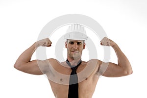 Muscular man wearing architect helmet