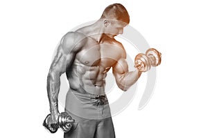 Muscular man working out doing exercises with dumbbells at biceps, strong male abs, isolated over white