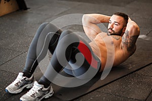 Muscular man working out in gym doing exercises.