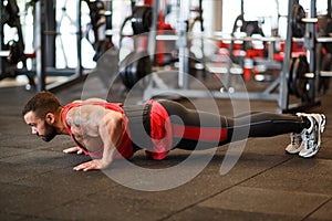Muscular man working out in gym doing exercises.