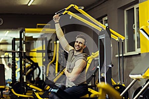 Muscular man working out in gym doing exercises