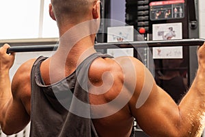 Muscular man working out in gym doing exercises,Exercise for triceps in the gym. strong male naked torso abs