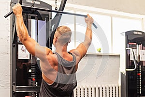 Muscular man working out in gym doing exercises,Exercise for triceps in the gym. strong male naked torso abs