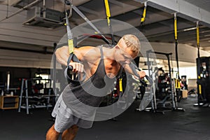 Muscular man working out in gym doing exercises,Exercise for triceps in the gym. strong male naked torso abs