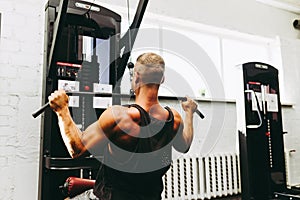 Muscular man working out in gym doing exercises,Exercise for triceps in the gym. strong male naked torso abs.Toned