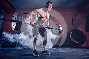 Muscular man working out in gym doing exercises, strong male naked torso abs