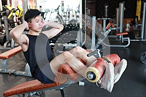 Muscular man working out in gym . Man doing situp crunches