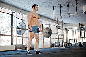 Muscular man workout with barbell