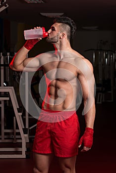 Muscular Men Drinking Water From Shaker