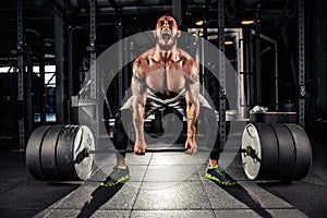 Muscular men lifting deadlift