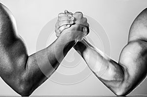 Muscular men measuring forces, arms. Hand wrestling, compete. Hands or arms of man. Muscular hand. Two men arm wrestling