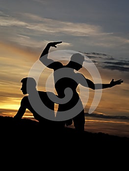 Muscular men in sunset with boxes