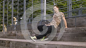 Muscular model man in khaki t-shirt on background.of outdoor gym.