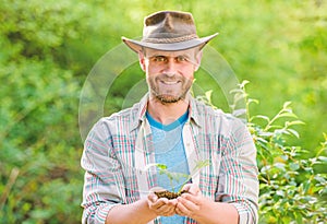 Muscular ranch man in cowboy hat care plants. Eco farm worker. Earth day. happy earth day. Eco living. farming and