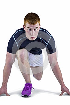 Muscular rugby player in running stance