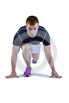 Muscular rugby player in running stance
