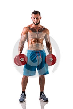 Muscular shirtless young man exercising biceps with dumbbells