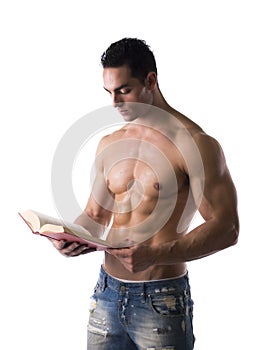 Muscular shirtless male bodybuilder reading book