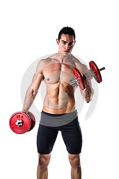 Muscular shirtless young man exercising biceps with dumbbells