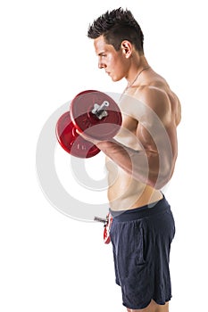 Muscular shirtless young man exercising biceps