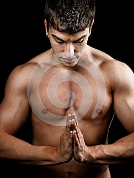 Muscular spiritual man doing yoga