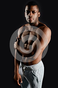 Muscular strong athlete demonstarting his body