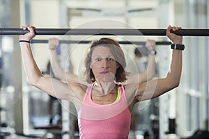 Muscular woman with barbell