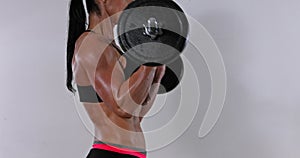 Muscular woman lifting curved barbell