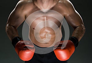 Muscular young caucasian boxer wearing boxing