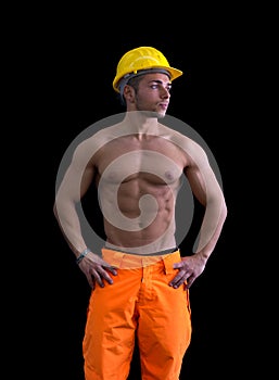 Muscular young construction worker shirtless wearing hardhat