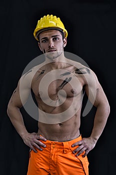 Muscular young construction worker shirtless
