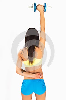 Muscular young girl with dumbbells