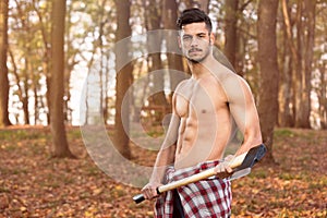 Muscular young man with axe