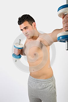 Muscular young man with dumbbells