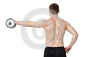 Muscular young man exercising with dumbbell.