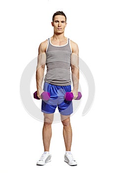 Muscular young man exercising in sports outfit