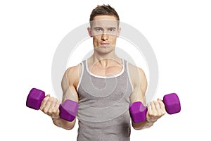 Muscular young man exercising in sports outfit