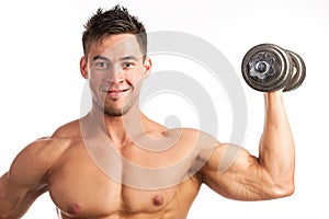 Muscular young man lifting a dumbbell