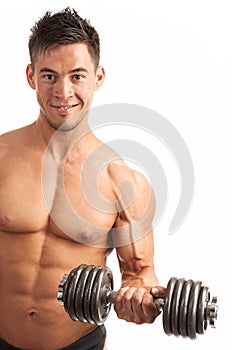 Muscular young man lifting a dumbbell over white