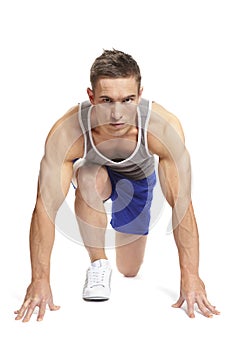 Muscular young man ready to race in sports outfit