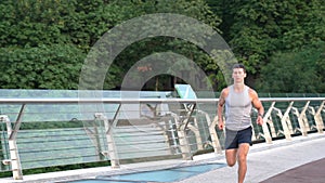 muscular young man runner in sportswear running and training stamina, sprint