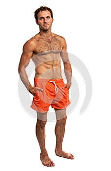 Muscular young man in swimwear standing photo