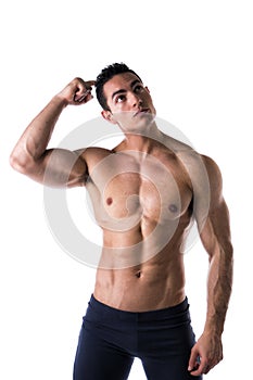Muscular young man unsure or confused, scratching head