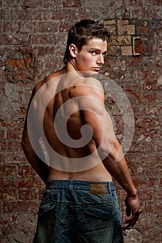 Muscular young naked man in jeans