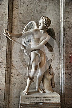 Statue of Eros stringing his bow photo