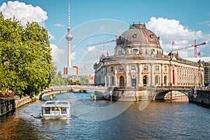 Museum Island, boat on river spree and Tv Tower during summer day in Berlin, Mitte