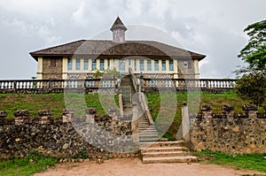 Museum at traditional palace of the Fon of Bafut with brick and tile buildings and jungle environment, Cameroon, Africa photo