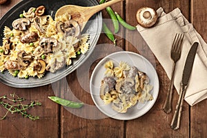 Mushroom and cheese pasta. Farfalle with cremini and green pea with ingredients